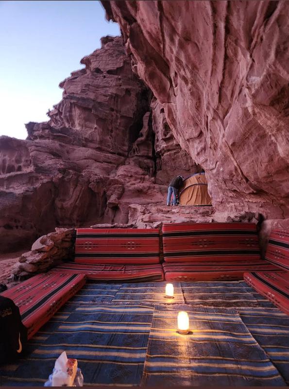 Candle-lit seating in a rock shelter