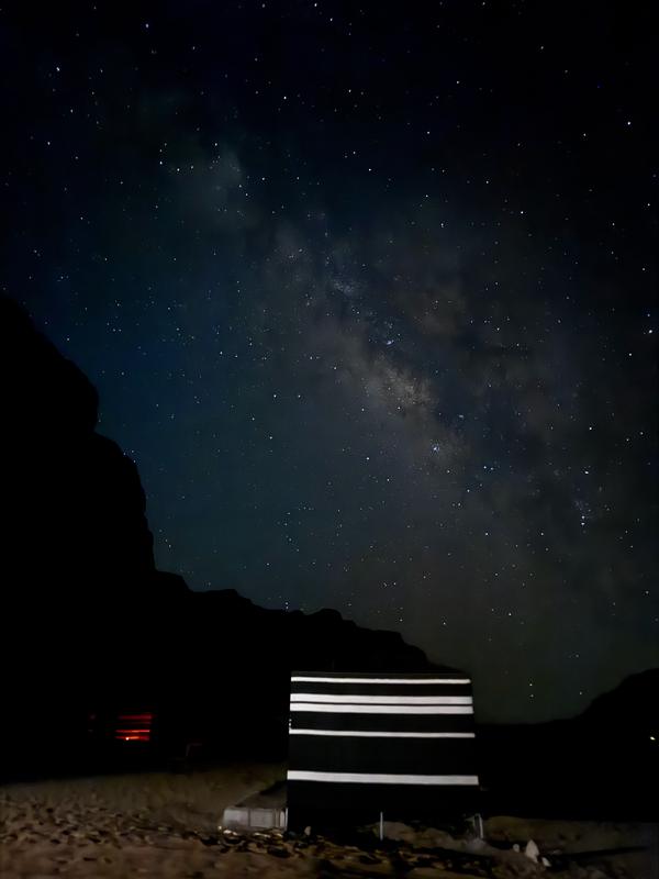 The Milky Way over a striped Bedouin tent at Desert Tree Camp
