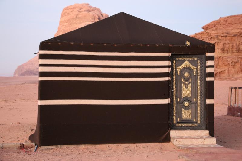 A black-and-white striped Bedouin tent